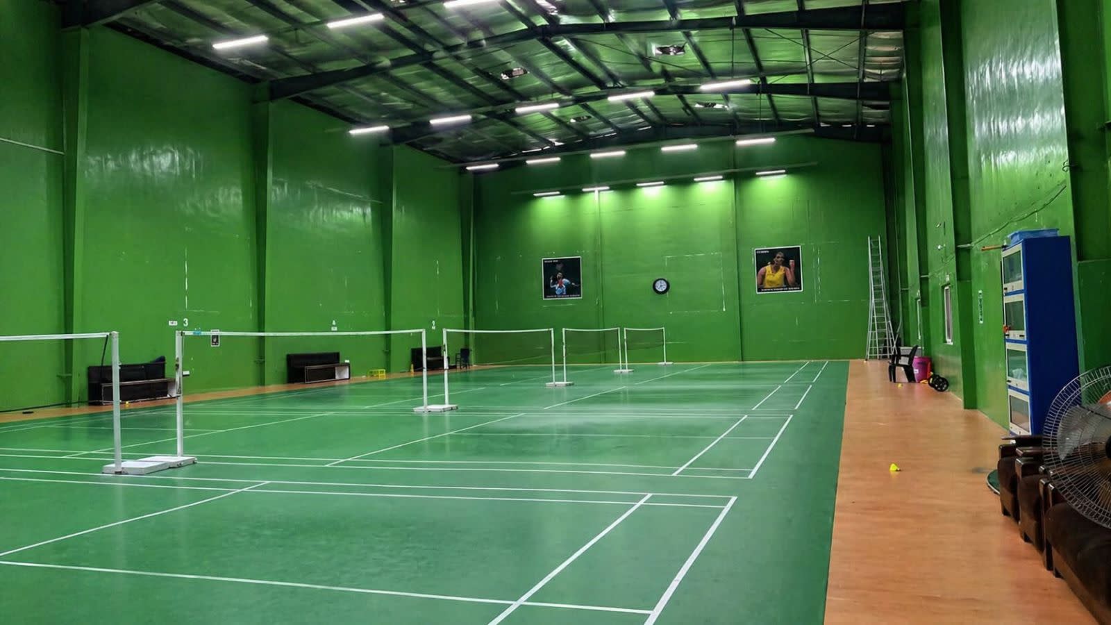 Premium synthetic badminton court mat with non-slip surface for professional and recreational play.